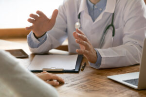 Close,Up,Of,Male,Doctor,In,White,Medical,Uniform,Sit