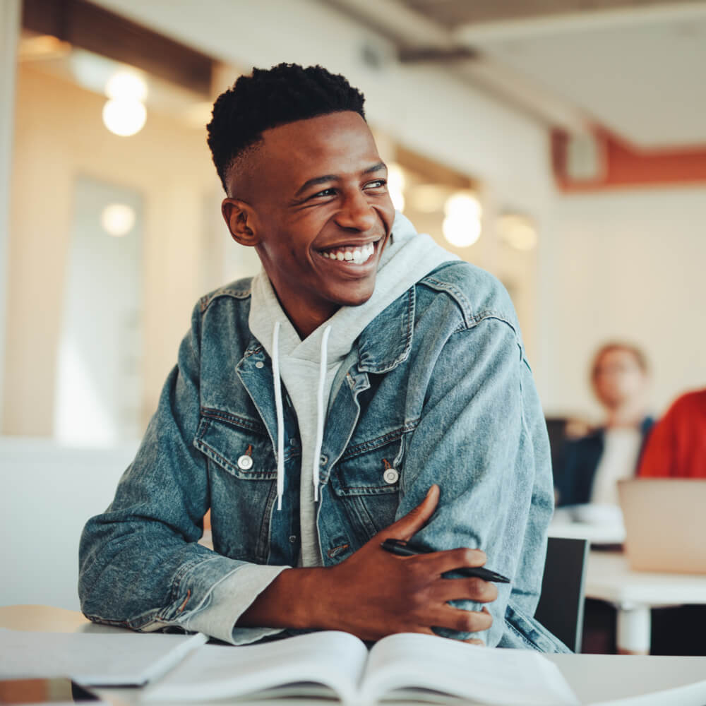 Male student sitting in university classroom