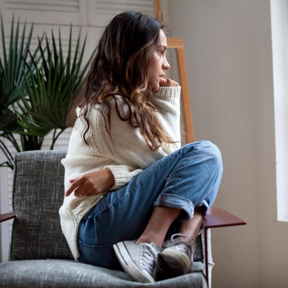 Sad thoughtful teen girl sits on chair feels depressed