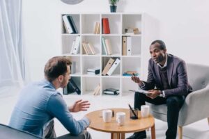 Psychiatrist talking to young male client