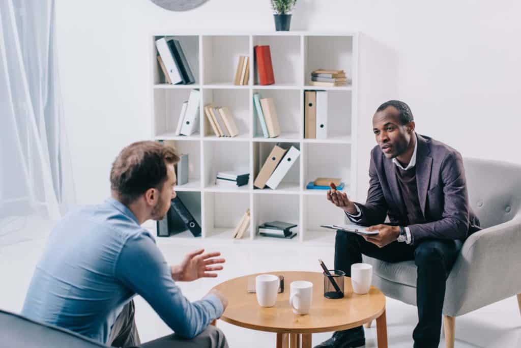 Psychiatrist talking to young male client
